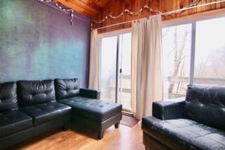 living room featuring wood ceiling and wood-type flooring