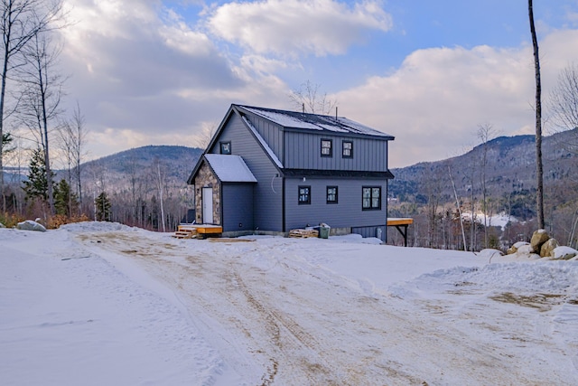 snow covered property with a mountain view