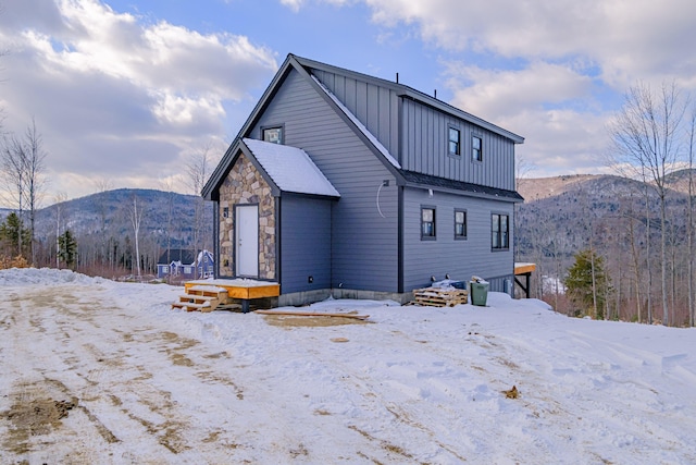 snow covered property featuring a mountain view