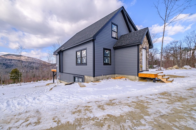 snow covered property featuring a mountain view