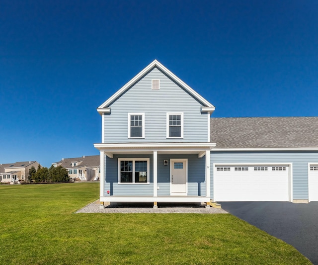 view of property with a garage, a front yard, and covered porch