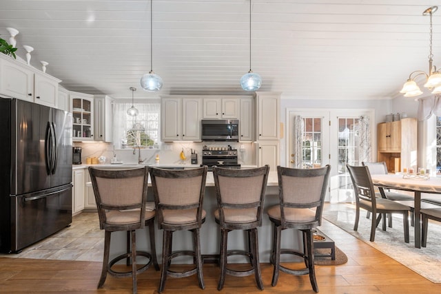 kitchen featuring appliances with stainless steel finishes, a center island, and white cabinets