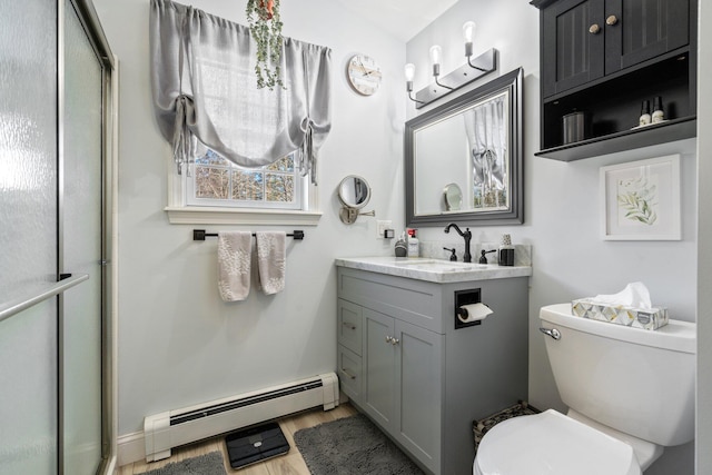 bathroom featuring toilet, an enclosed shower, wood-type flooring, a baseboard radiator, and vanity