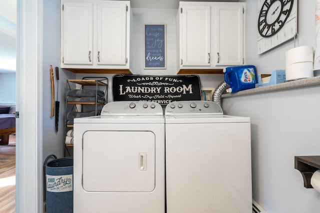 washroom with cabinets and separate washer and dryer