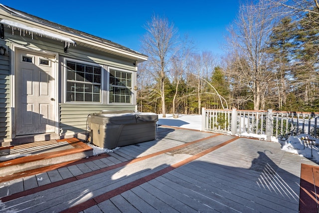 snow covered deck featuring a hot tub