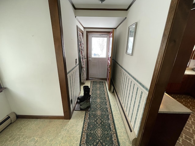 corridor with ornamental molding and a baseboard heating unit