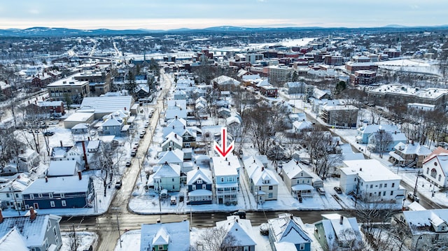 snowy aerial view featuring a mountain view