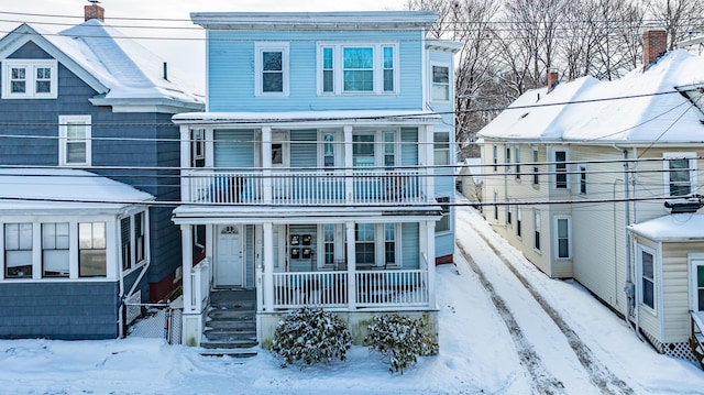 view of front of home featuring a balcony and covered porch