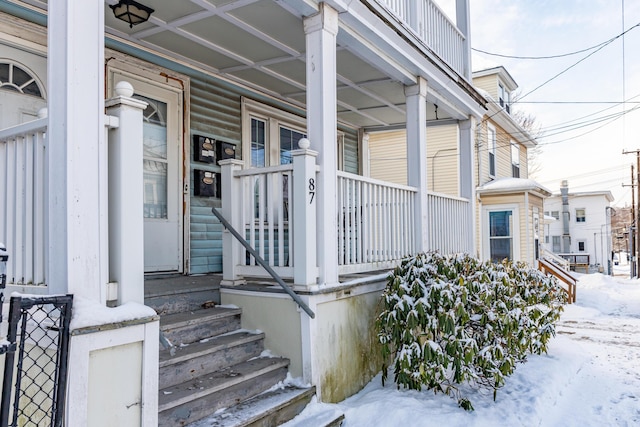 view of snow covered property entrance