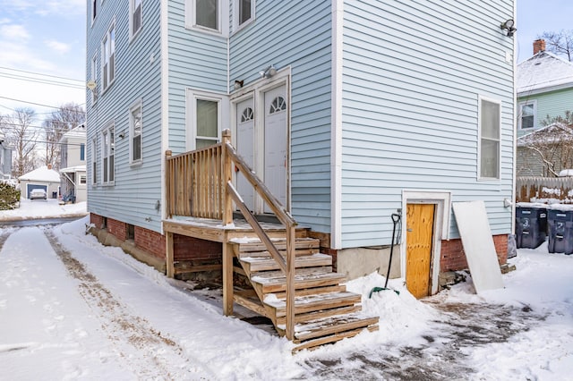 view of snow covered property entrance