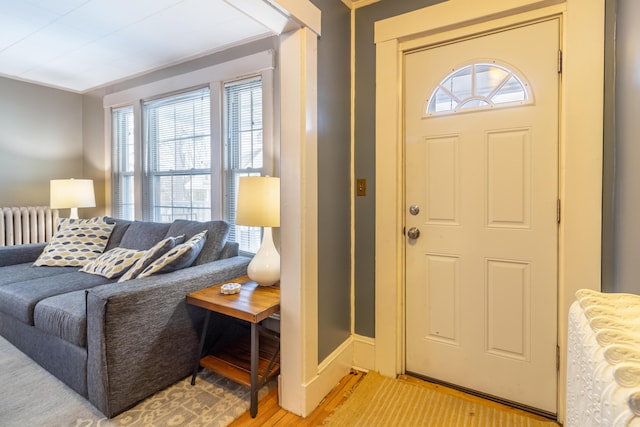 foyer featuring hardwood / wood-style flooring and radiator heating unit