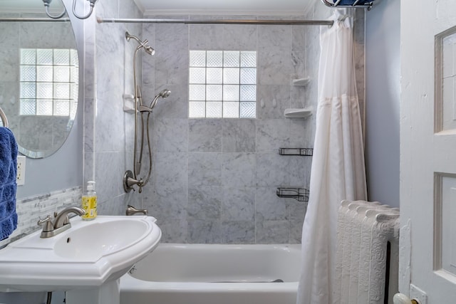 bathroom featuring crown molding, sink, shower / bath combo with shower curtain, and backsplash