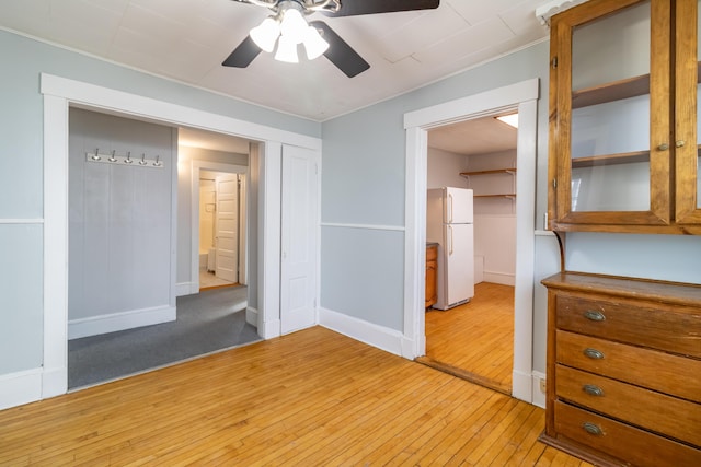 spare room with ceiling fan and light hardwood / wood-style floors