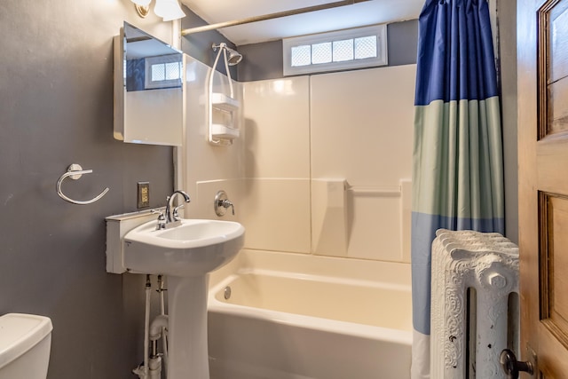 bathroom featuring shower / bath combo and toilet