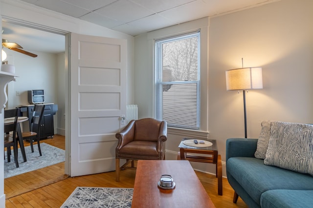 sitting room featuring lofted ceiling, wood-type flooring, and ceiling fan