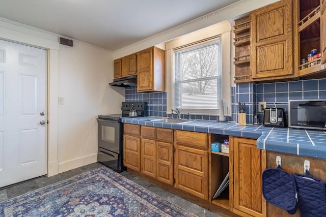 kitchen featuring backsplash, tile countertops, sink, and black appliances