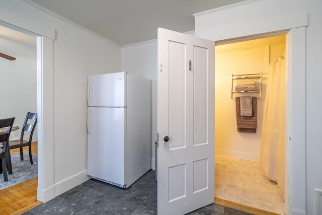 kitchen with ornamental molding and white fridge