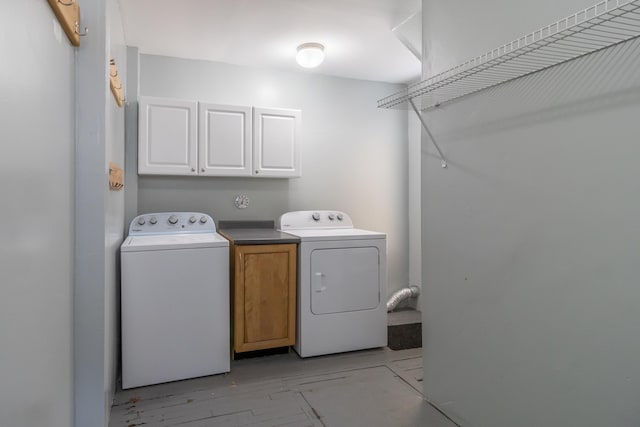 washroom featuring cabinets and washer and dryer