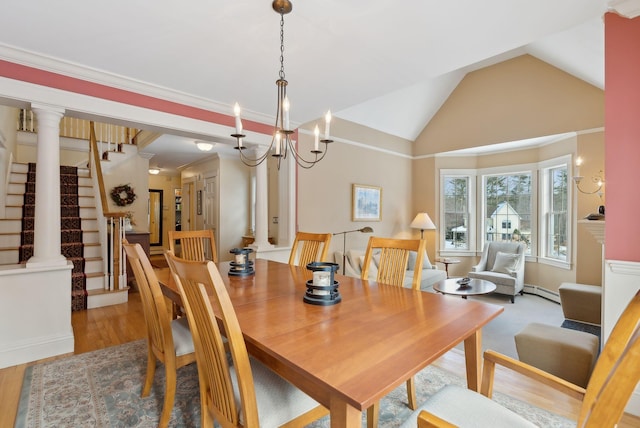 dining space with a baseboard radiator, lofted ceiling, light hardwood / wood-style floors, and ornate columns