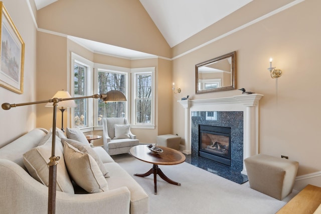 sitting room with crown molding, vaulted ceiling, and a premium fireplace