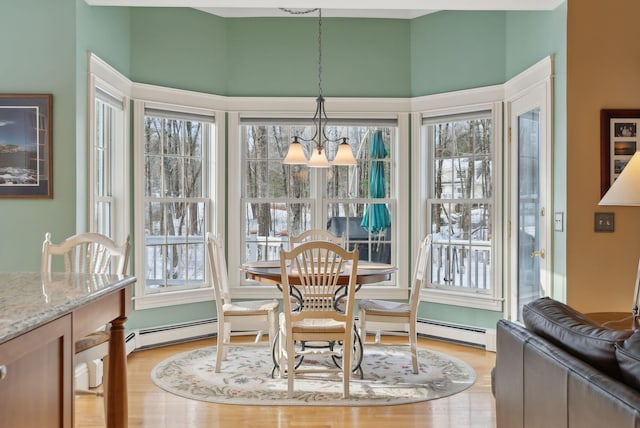 dining area with a notable chandelier and light wood-type flooring