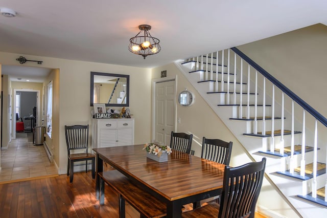 dining area with baseboard heating and dark wood-type flooring