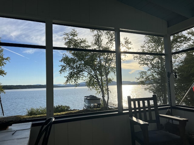 sunroom / solarium featuring a water view