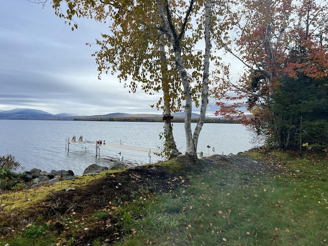 exterior space with a water and mountain view