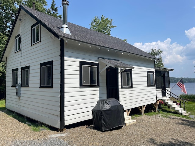 back of property featuring a shingled roof and entry steps