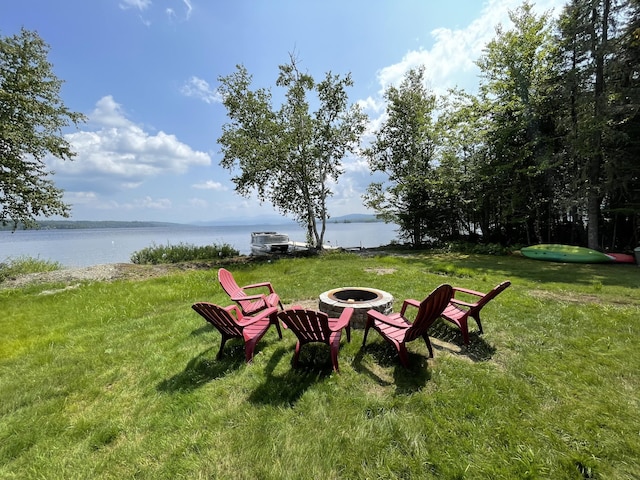 view of yard with a water view and a fire pit