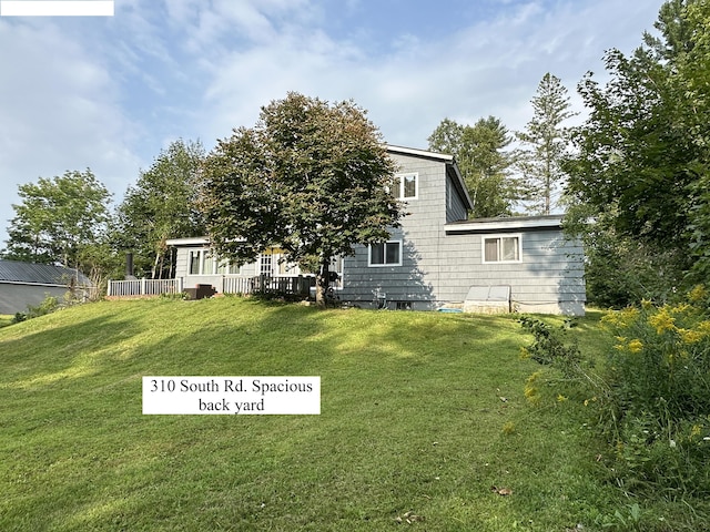 back of house with a yard