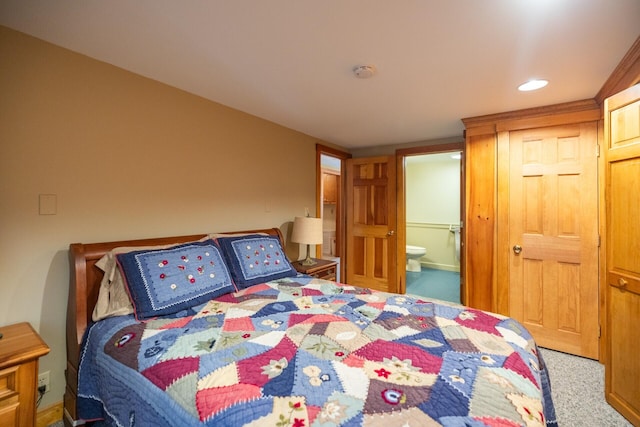 carpeted bedroom featuring ensuite bath