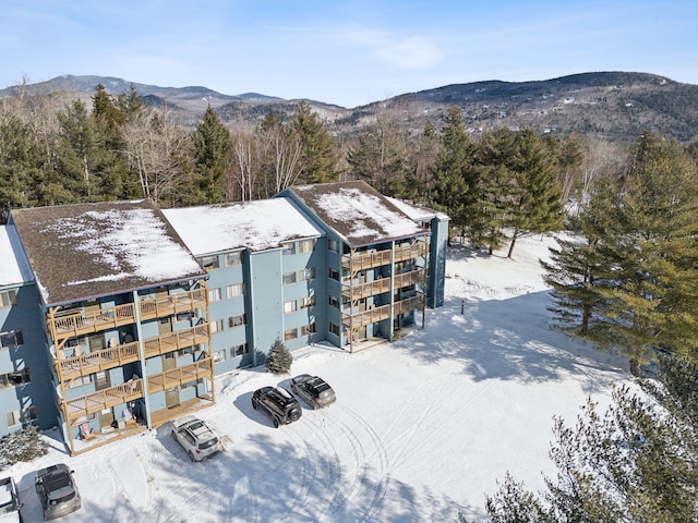 snowy aerial view featuring a mountain view