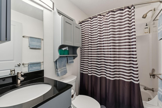 full bathroom featuring vanity, toilet, a textured ceiling, and shower / bath combo