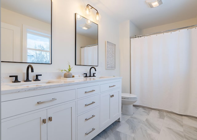 bathroom featuring vanity and toilet