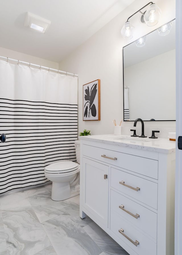 bathroom featuring vanity and toilet