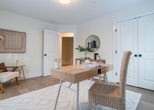 office with light hardwood / wood-style flooring