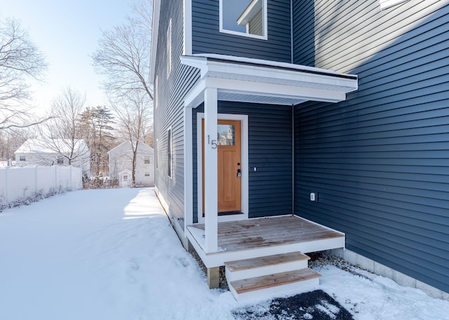 view of snow covered property entrance