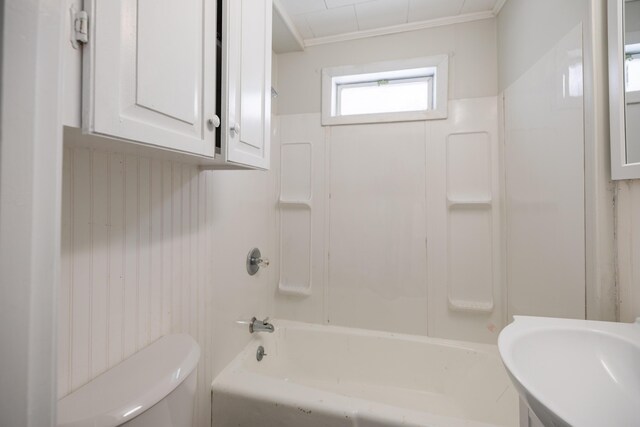 bathroom featuring shower / washtub combination, a sink, and toilet