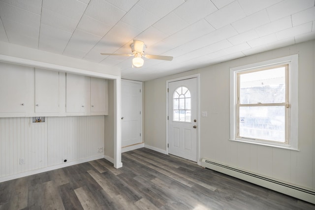 foyer entrance with baseboards, a baseboard radiator, a ceiling fan, and dark wood-style flooring