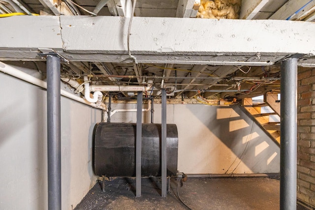 unfinished basement featuring heating fuel