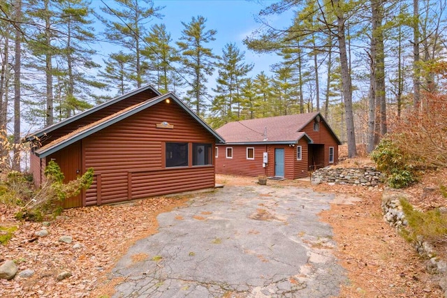 48 Green Bay Rd, Newfield, ME 04095 - view of front facade featuring faux log siding and asphalt driveway