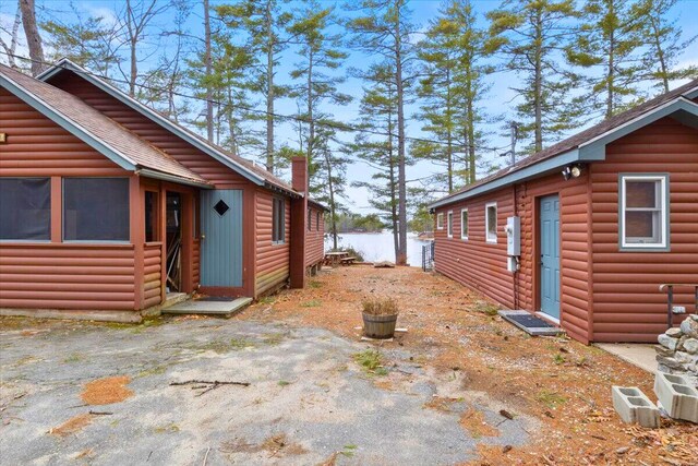 48 Green Bay Rd, Newfield, ME 04095 - view of side of property with faux log siding and a shingled roof