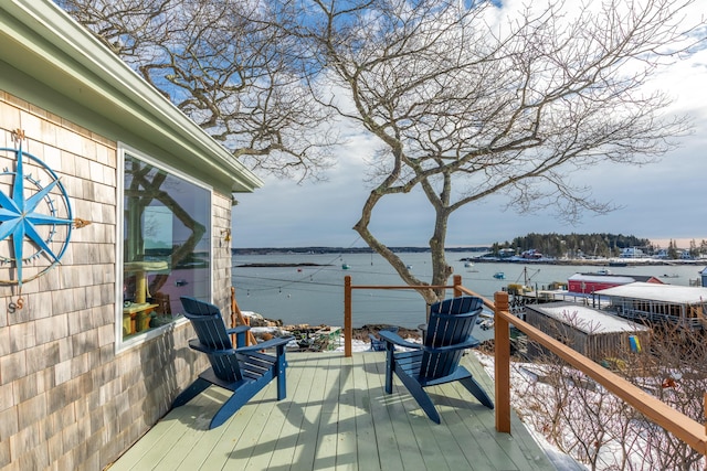 wooden terrace featuring a water view