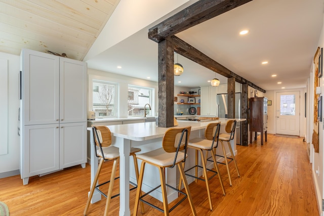 dining space with a wealth of natural light, recessed lighting, and light wood-style flooring