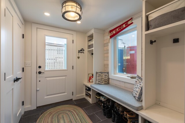 mudroom with recessed lighting and dark tile patterned flooring