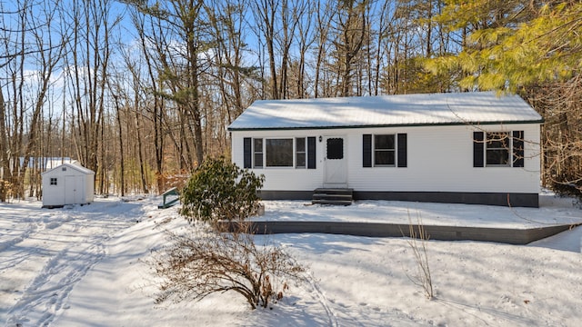 view of front of house with a storage shed