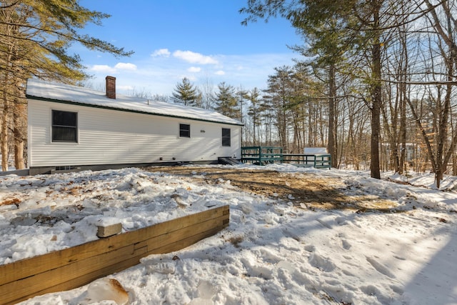 snow covered property featuring a wooden deck