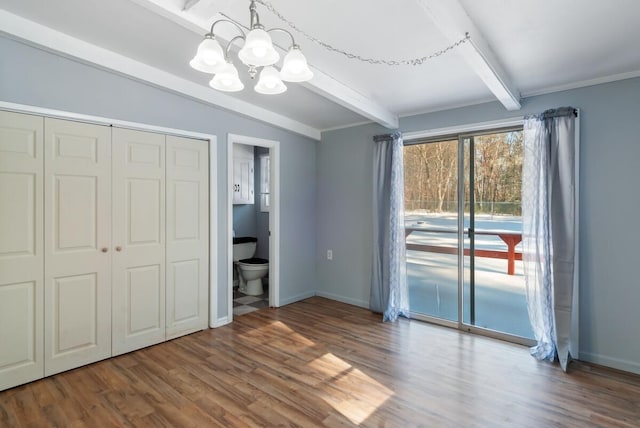 unfurnished bedroom featuring connected bathroom, vaulted ceiling with beams, a chandelier, access to outside, and hardwood / wood-style flooring