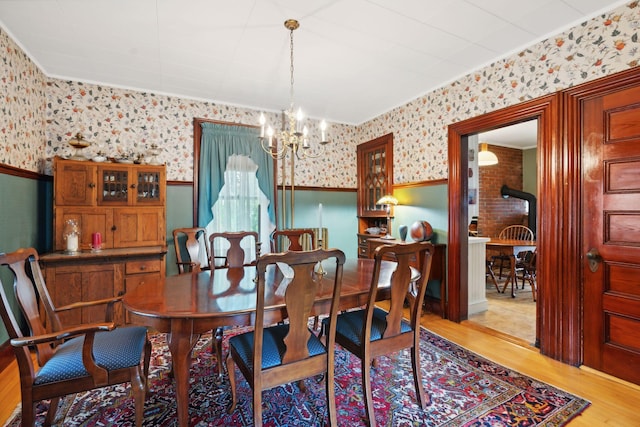 dining space with a chandelier and light wood-type flooring